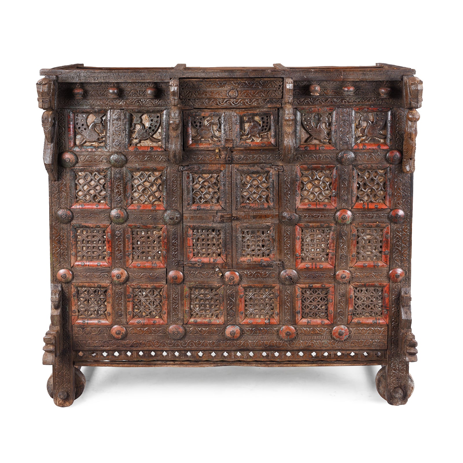 Antique 19th-century Indian dowry chest from Gujarat with intricate animal carvings, geometric patterns, and hidden compartments, set on wheels.