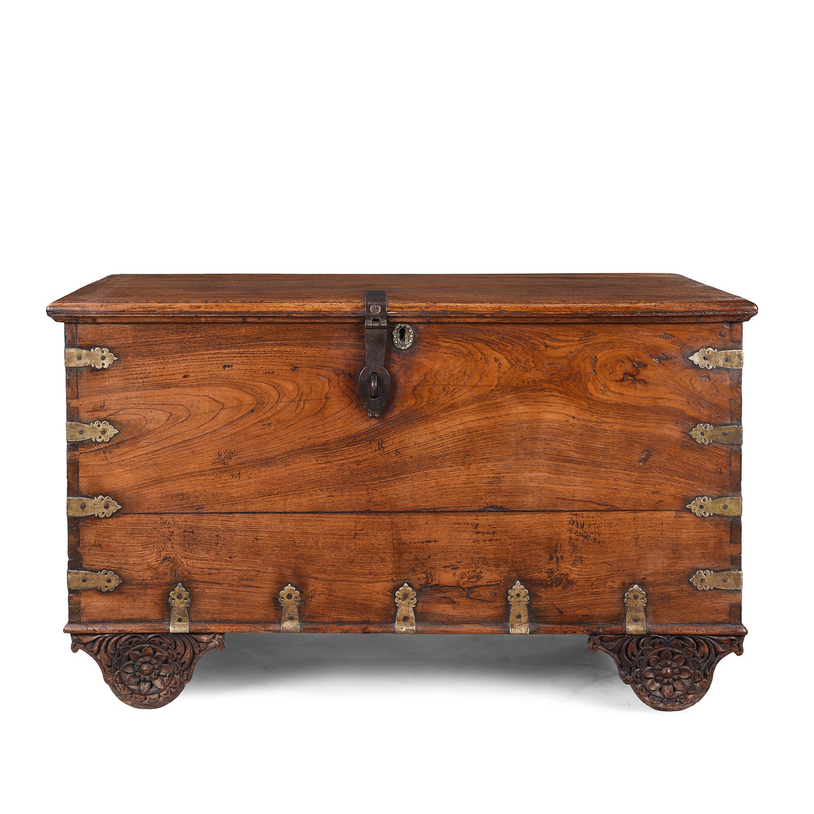 Antique mid-19th century teak chest from Gujarat with hidden wheels, carved floral feet, and original iron fittings.