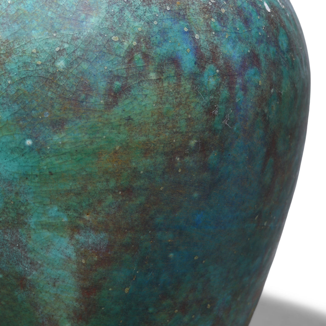 Detail From Small handmade Jingdezhen porcelain vase with green copper yaobian glaze in mottled turquoise, teal and deep blue with reddish-brown tones and a fine crackled surface.