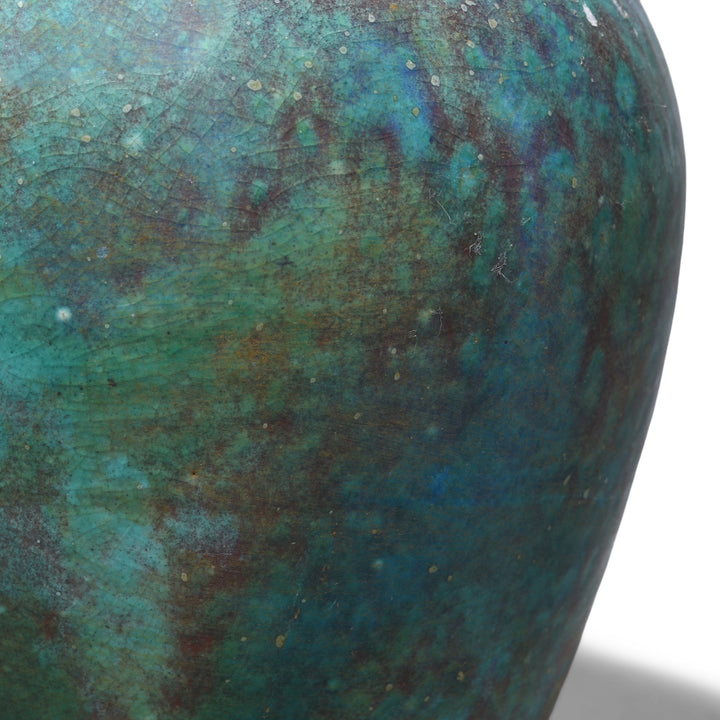 Detail From Small handmade Jingdezhen porcelain vase with green copper yaobian glaze in mottled turquoise, teal and deep blue with reddish-brown tones and a fine crackled surface.