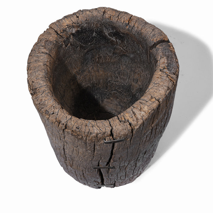 Interior Of 19th century oak pepper mortar from South China with deeply weathered timber and historic iron repairs | Indigo Antiques