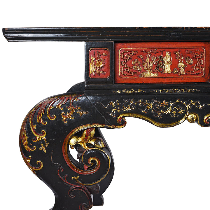 Corner Detail Showing Leg And Gilt panel On 19th-Century Chinese Fujian Altar Table With Red And Black Lacquer, Hand-Painted Gilt Panels, And Ornate Carved Legs