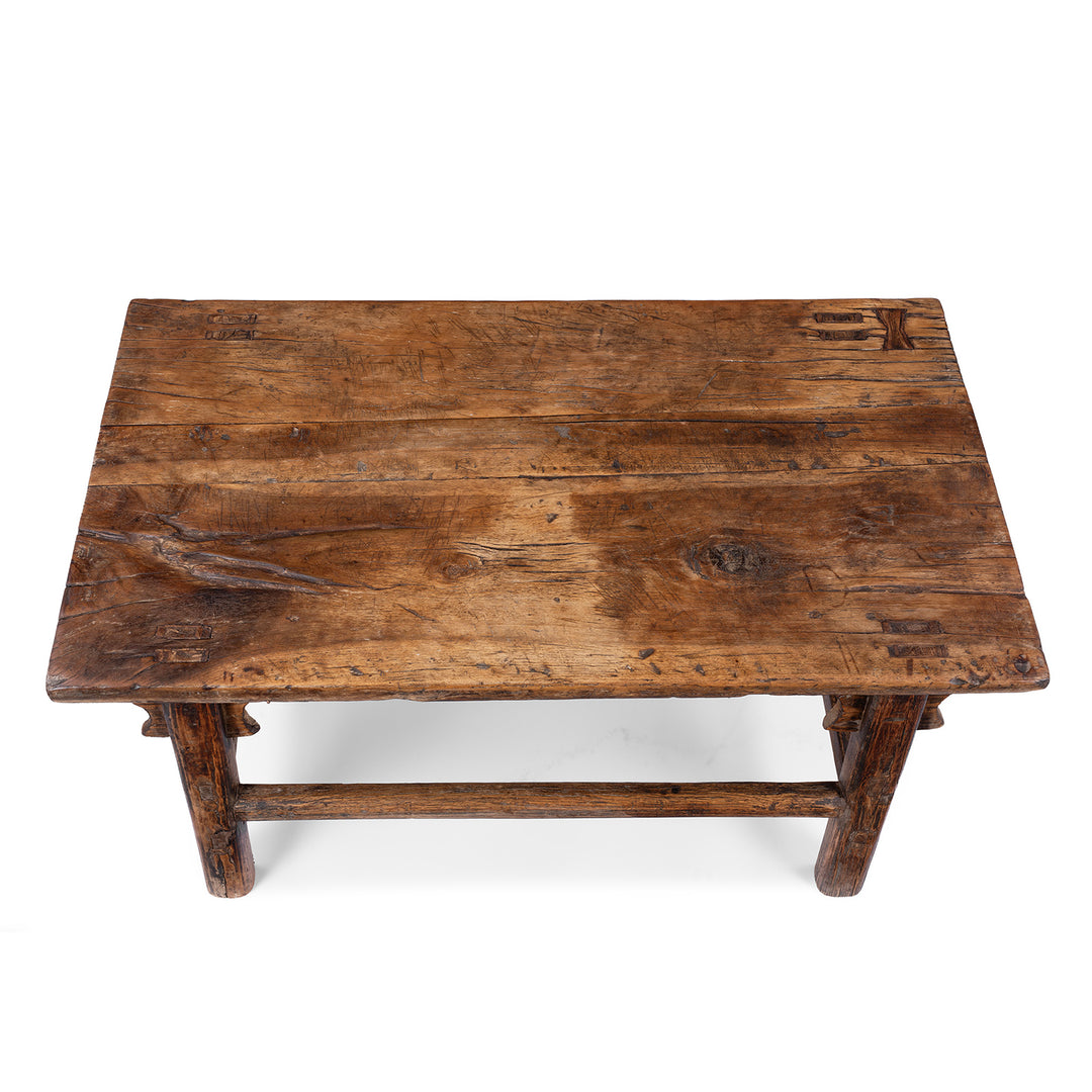 Top Down View Of Antique circa 1910 Chinese walnut farmhouse coffee table from Henan with thick plank top, traditional mortise-and-tenon joinery and rich aged patina.