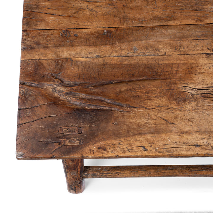 Detail From Surface Of Antique circa 1910 Chinese walnut farmhouse coffee table from Henan with thick plank top, traditional mortise-and-tenon joinery and rich aged patina.