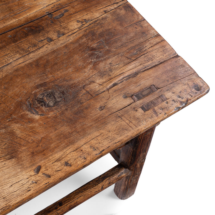 Detail From Surface Of Antique circa 1910 Chinese walnut farmhouse coffee table from Henan with thick plank top, traditional mortise-and-tenon joinery and rich aged patina.