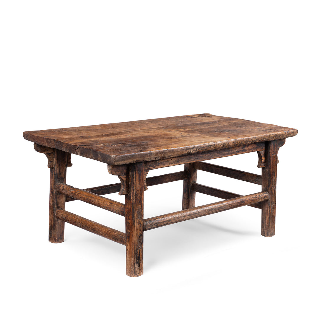 Angled View Of Antique circa 1910 Chinese walnut farmhouse coffee table from Henan with thick plank top, traditional mortise-and-tenon joinery and rich aged patina.