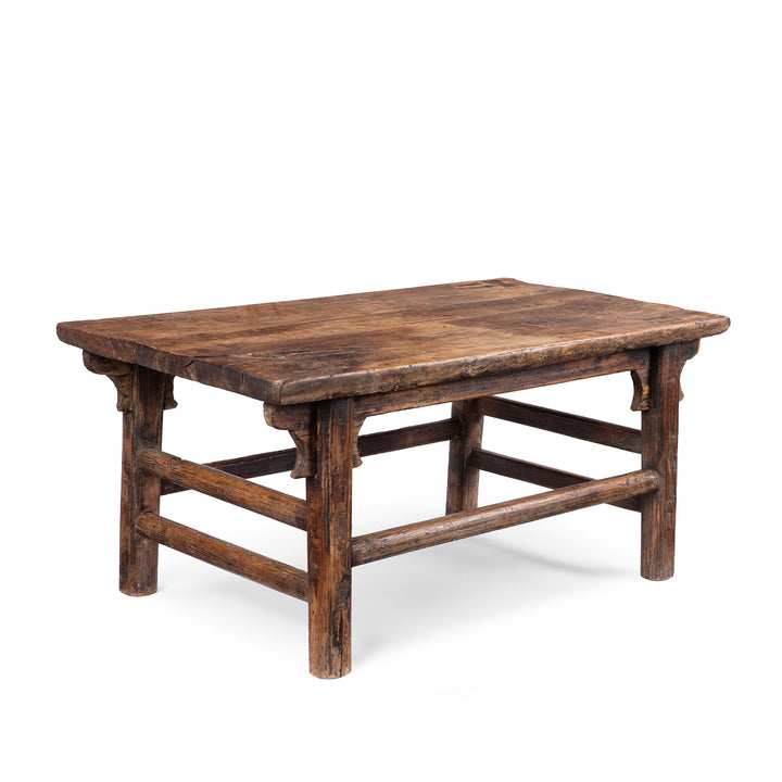 Angled View Of Antique circa 1910 Chinese walnut farmhouse coffee table from Henan with thick plank top, traditional mortise-and-tenon joinery and rich aged patina.
