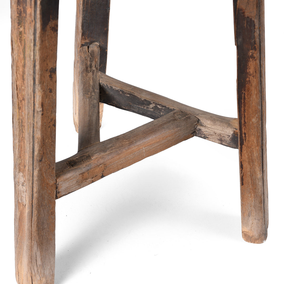 Close-up of a rustic wooden stool with a white background