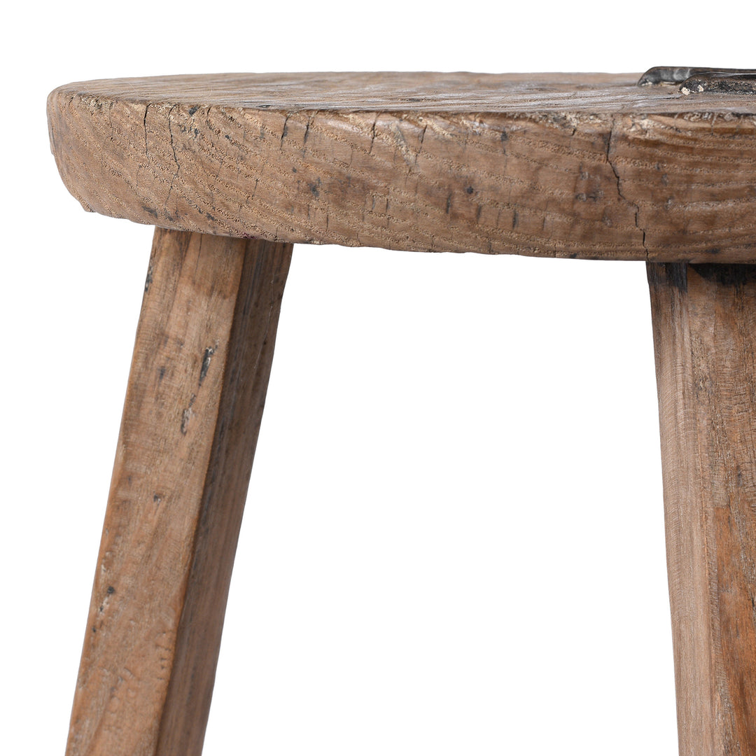 Close-up of a rustic wooden stool with a white background