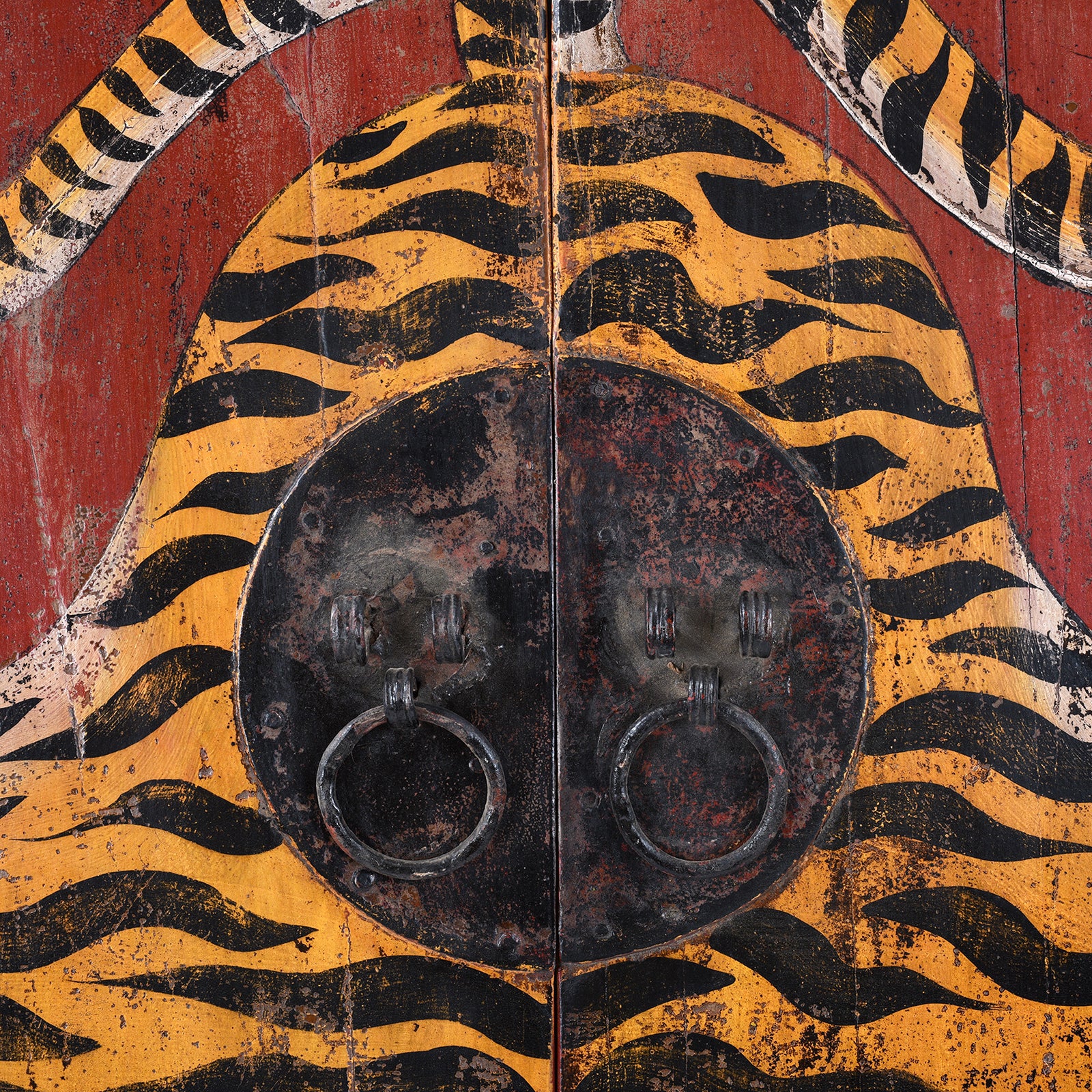 Metallic Door Plate Detail From Hand Painted Reproduction Qinghai Tiger Doors With Stylised Striped Motif On Distressed Red Background