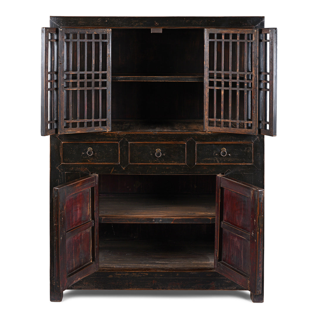 Interior View Of Antique Chinese Black Lacquered Cabinet With Upper Lattice Doors And Lower Panelled Cupboard And Drawer Section