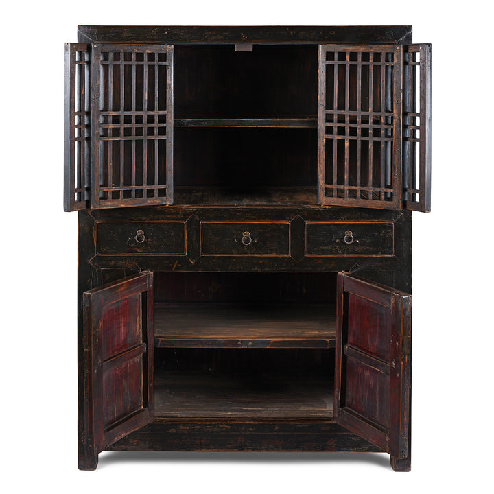 Interior View Of Antique Chinese Black Lacquered Cabinet With Upper Lattice Doors And Lower Panelled Cupboard And Drawer Section