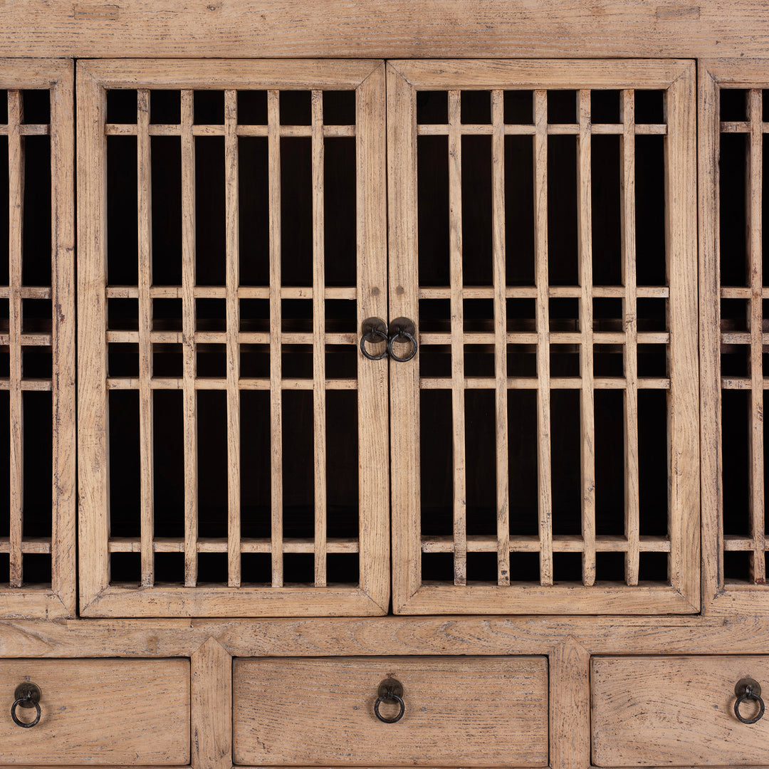 Wooden cabinet with grid-patterned doors and visible hardware