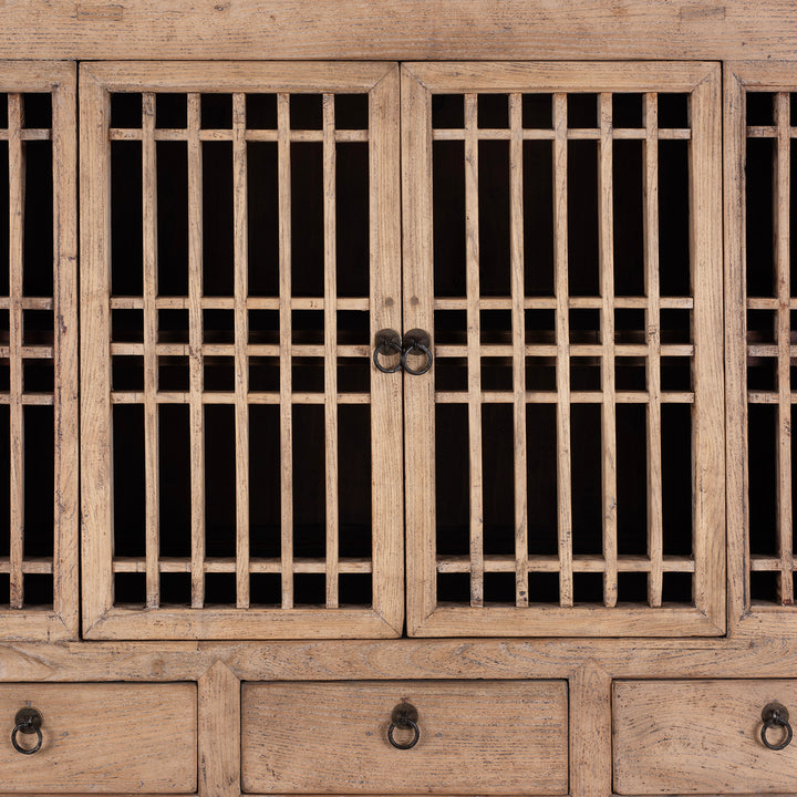 Wooden cabinet with grid-patterned doors and visible hardware