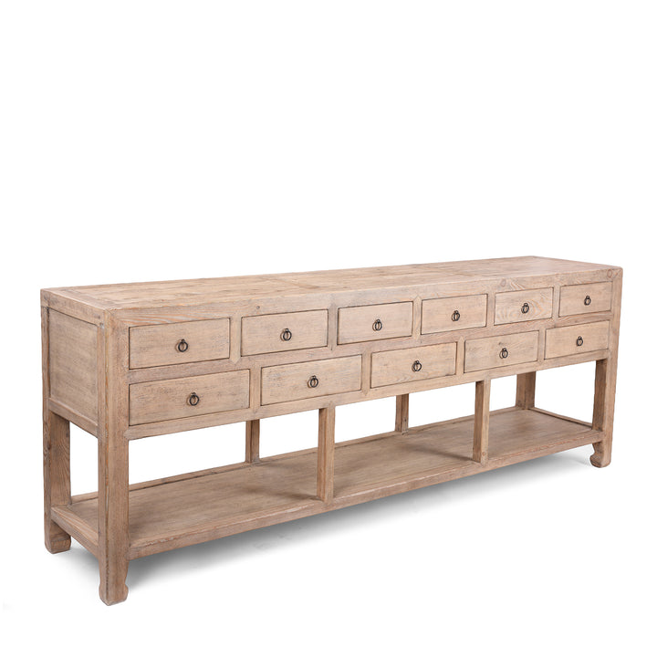 Angled View Of Long Chinese Console Table With Eleven Drawers And Open Shelf Made From Lightly Weathered Old Pine Wood