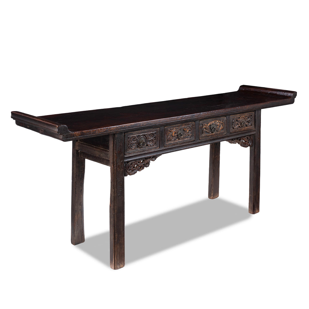 Angled View Of Carved Elm Shanxi Altar Table With Floral Drawers And Dark Patinated Lacquer | Indigo Antiques