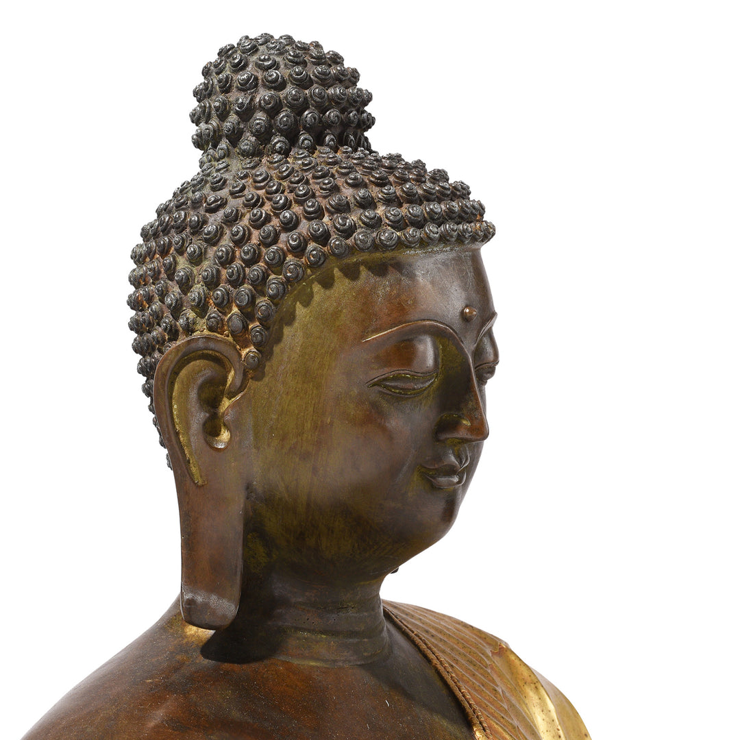 Angled View Of Gilt Bronze Sitting Buddha Statue - Varada Mudra | Indigo Antiques