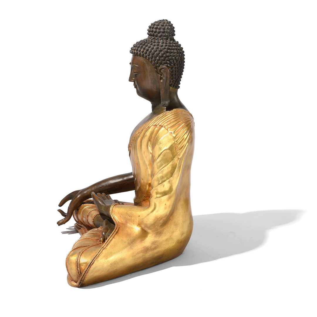 Side View Of Gilt Bronze Sitting Buddha Statue - Varada Mudra | Indigo Antiques