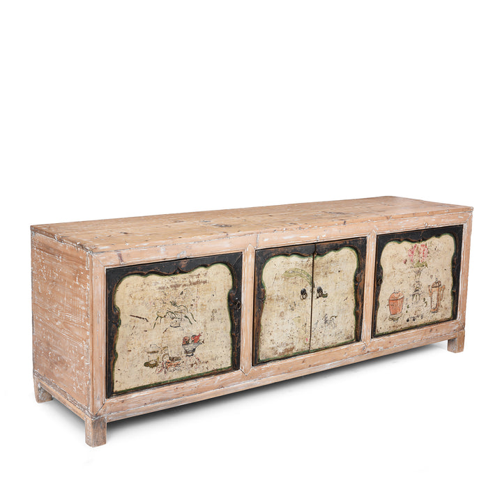 Angled View Of Antique Chinese Sideboard With Hand-Painted Floral And Figurative Panels In A Distressed Natural Wood Frame