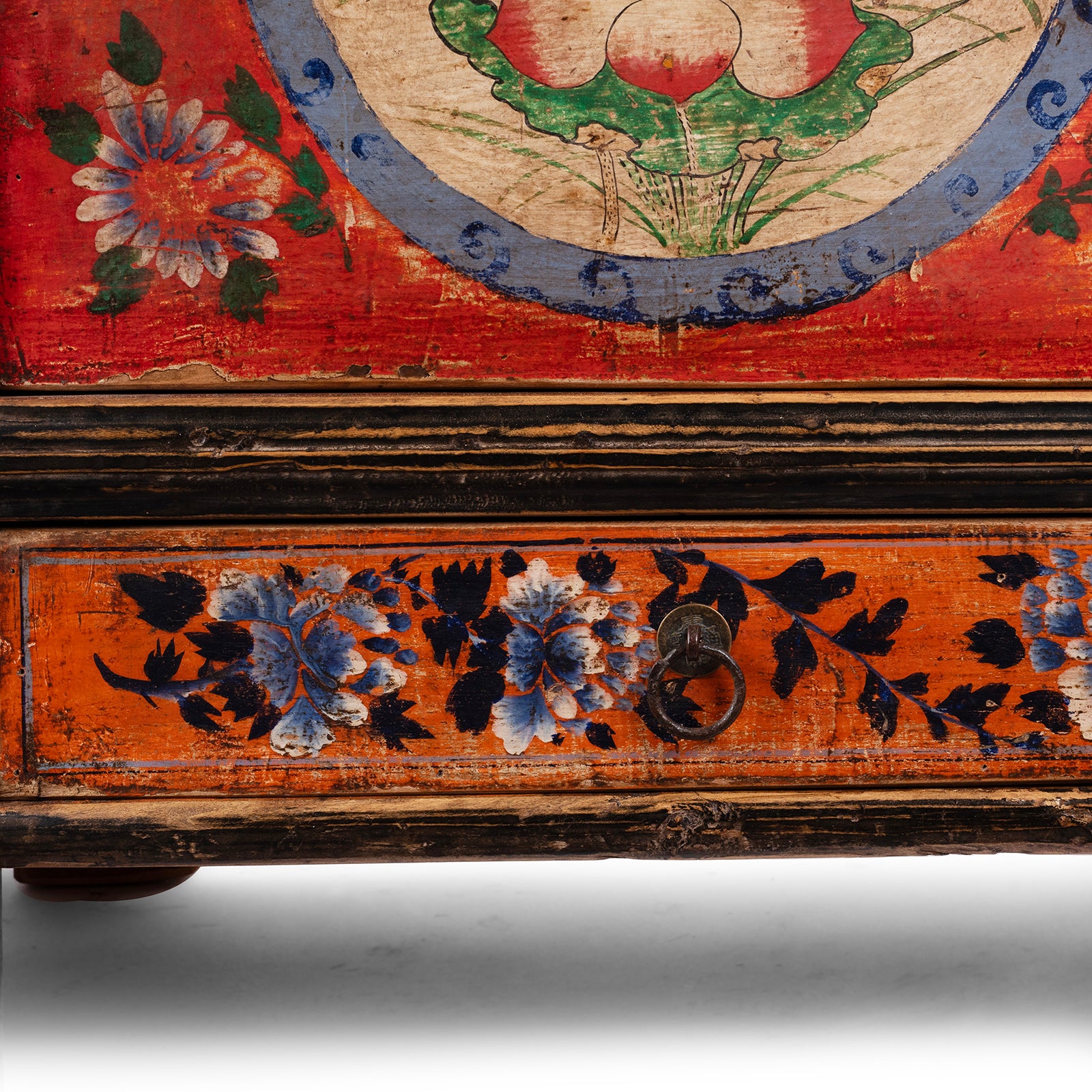Close-up of a wooden surface with floral designs and a decorative border.