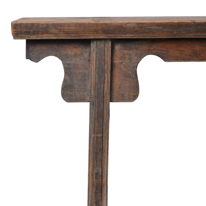 Corner Detail From 19th century Chinese rustic solid walnut farm bench with thick plank top, trestle legs, original patina and traces of historic dark lacquer | Indigo Antiques