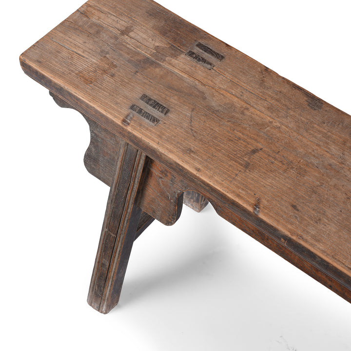 Detail From 19th century Chinese rustic solid walnut farm bench with thick plank top, trestle legs, original patina and traces of historic dark lacquer | Indigo Antiques