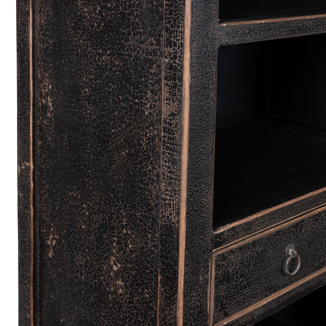 Crackling Detail From Tall Black Distressed Pine Shelf Unit With Geometric Open Compartments And Drawers