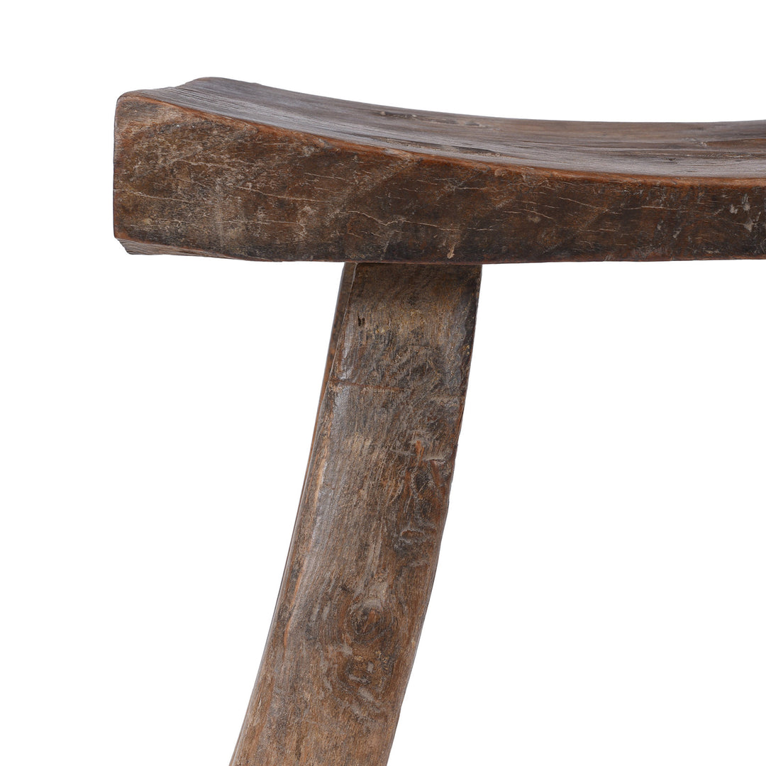 Corner Detail From Rustic 19th Century Elm Saddle Stool With Hand Shaped Seat And Stretcher Supports Showing Natural Patina And Age Wear