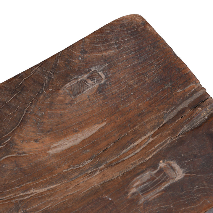 Detail From Top Of Rustic 19th Century Elm Saddle Stool With Hand Shaped Seat And Stretcher Supports Showing Natural Patina And Age Wear