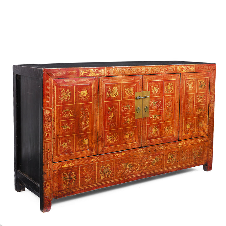 Angled View Of Red Lacquer Chinese Dongbei Sideboard With Hand-Painted Floral Panels And Brass Hardware