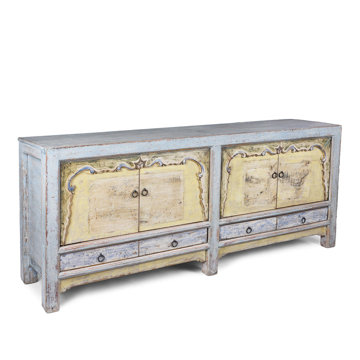 Angled View Of Early 20th Century Painted Sideboard From Qinghai Province China With Blue Frame And Soft Yellow Landscape Doors And Drawers