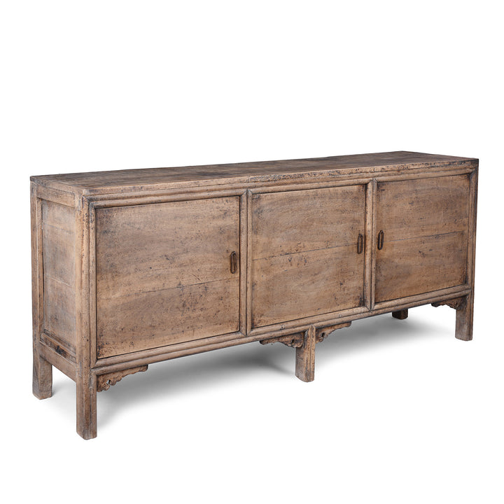 Angled VIew Of 19th Century Walnut Sideboard From Shaanxi Province China With Three Doors And Carved Lower Apron
