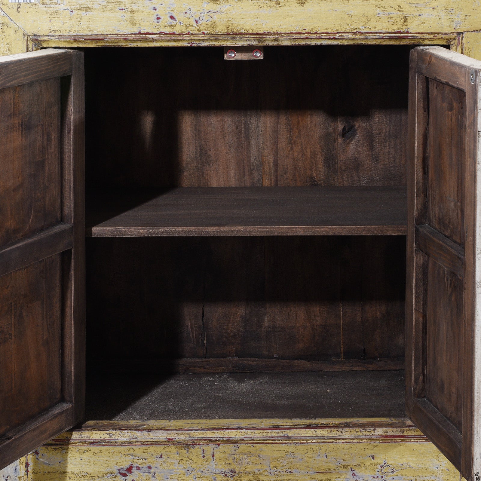Interior View Of Antique Six Door Mongolian Painted Sideboard Made From Old Wood With Scalloped Yellow And White Decoration And Shelved Interior
