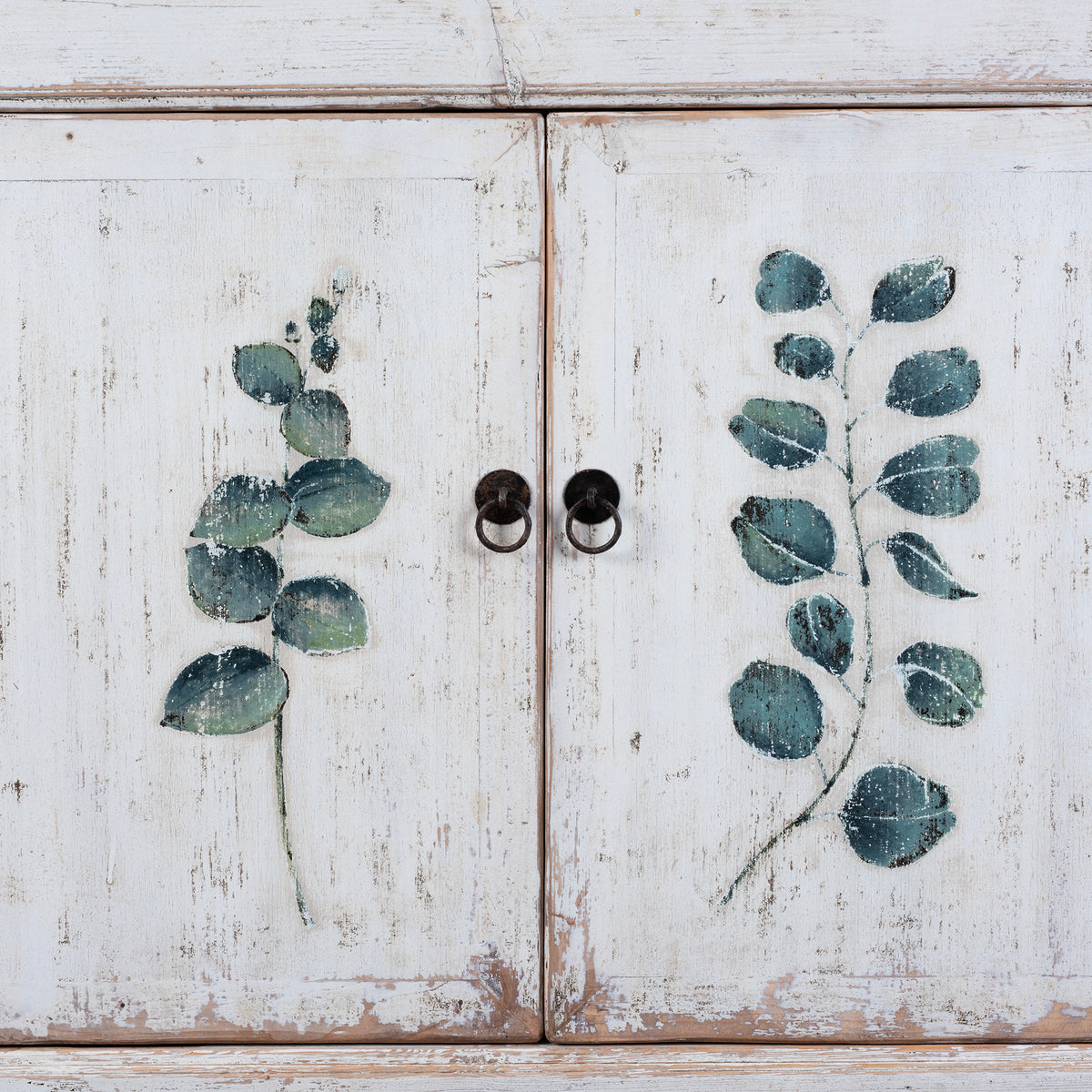 Detailed View Of Paintwork From Distressed White Chinese Side Cabinet With Hand Painted Botanical Motifs On Double Doors