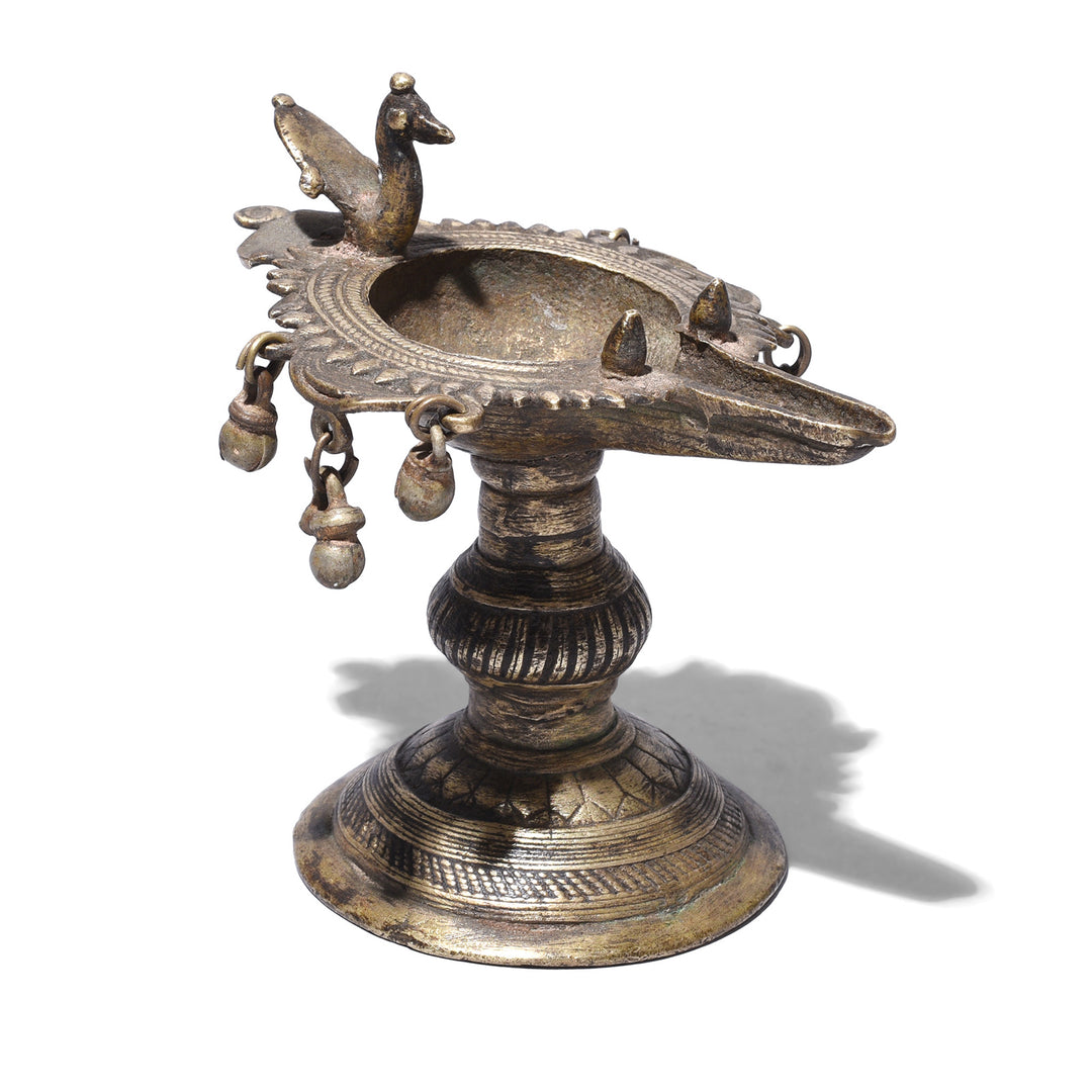 Circa 1920 Dhokra Brass Oil Lamp From Chhattisgarh With Peacock Finial And Suspended Bell Ornaments Cast Using Lost Wax Technique