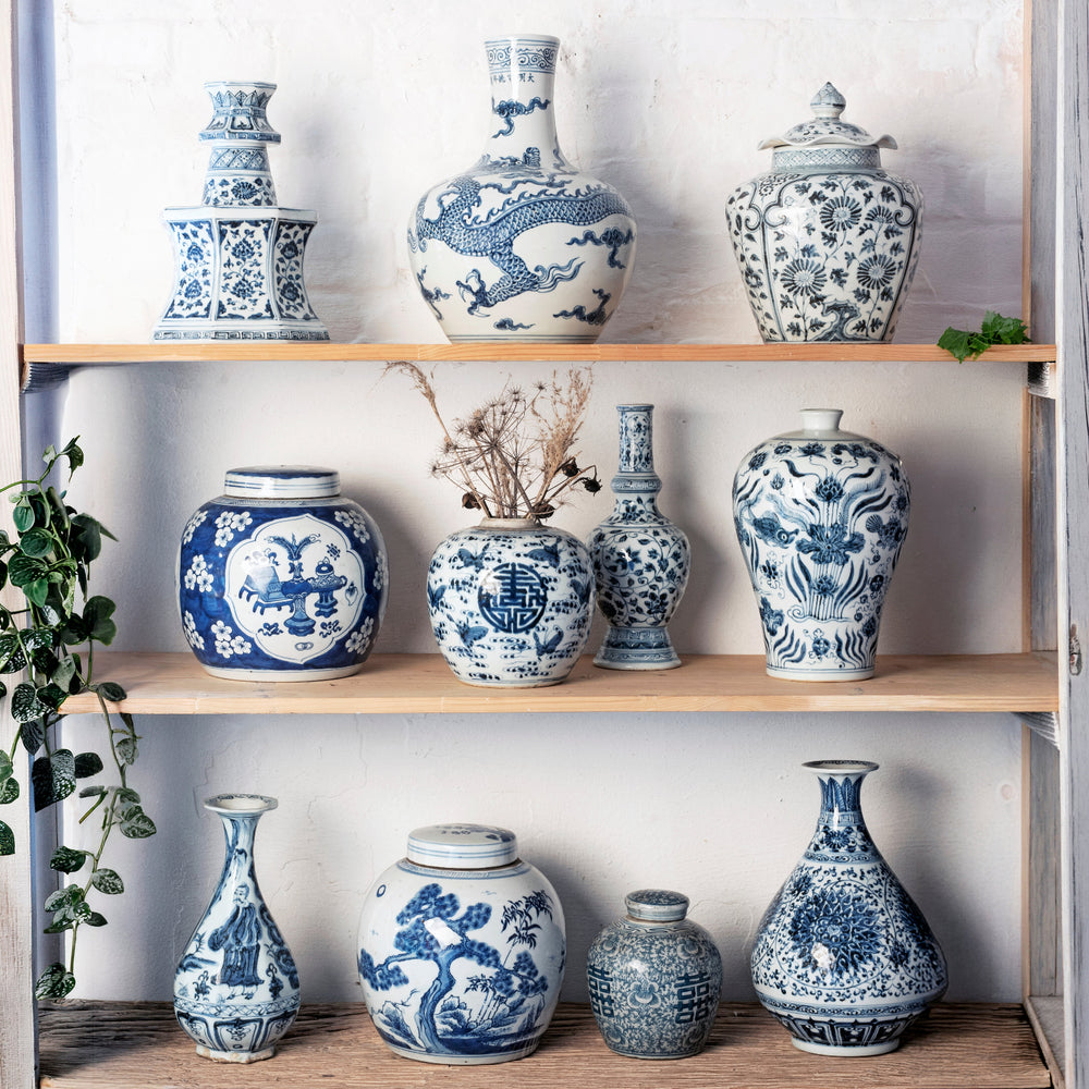 Chinese blue & white porcelain jars & vases crafted in the Qing & Ming style in a bleached shelf.