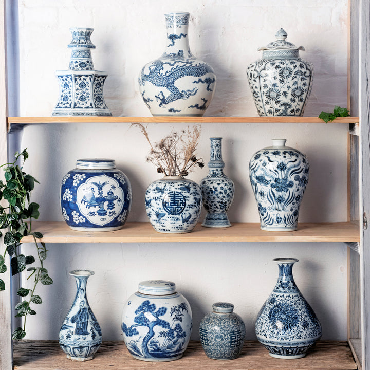 Chinese blue & white porcelain jars & vases crafted in the Qing & Ming style in a bleached shelf.