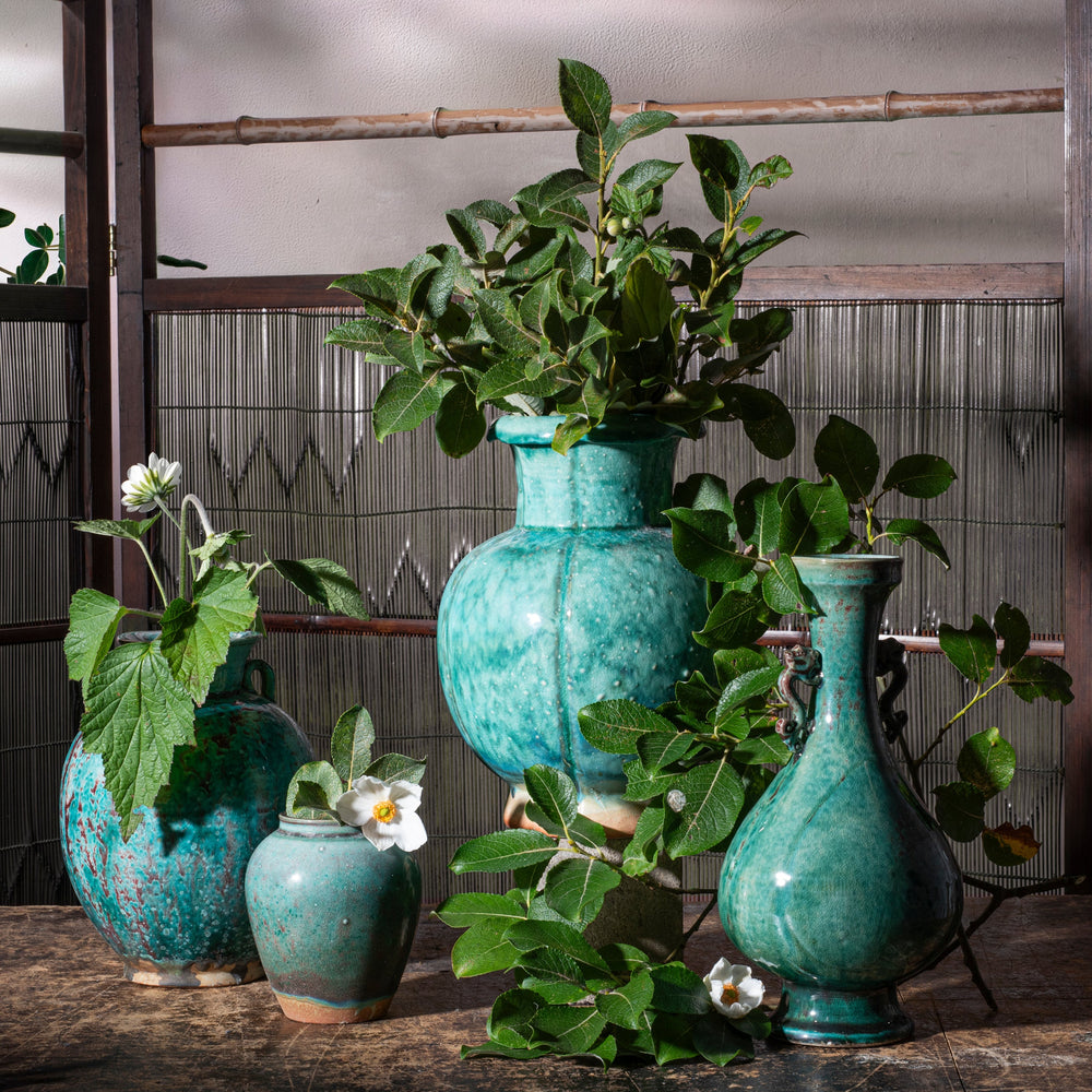 Copper green glaze flambe porcelain hand crafted in Jingdezhen, the porcelain capital of China on a background of Japanese screens