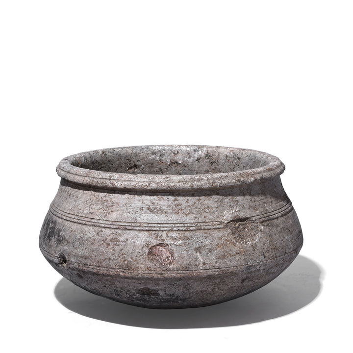 Indian Nineteenth Century Hand Carved Stone Water Pot With Carved Grooves And Aged Surface Used As A Planter