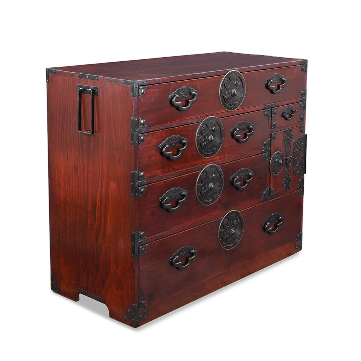 Angled View Of Antique Japanese Isho Dansu Chest Of Drawers With Mokko Drawer Pulls And Ornate Iron Hardware
