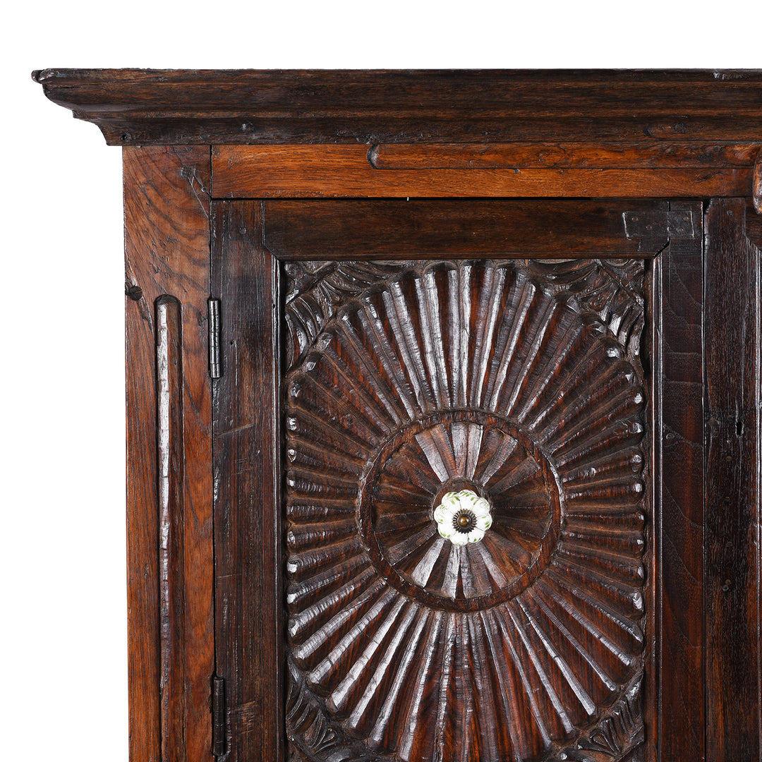 Corner Detail From Indian Teak Almirah Cabinet With Hand-Carved Sunburst Panels, Two Drawers And White Ceramic Handles