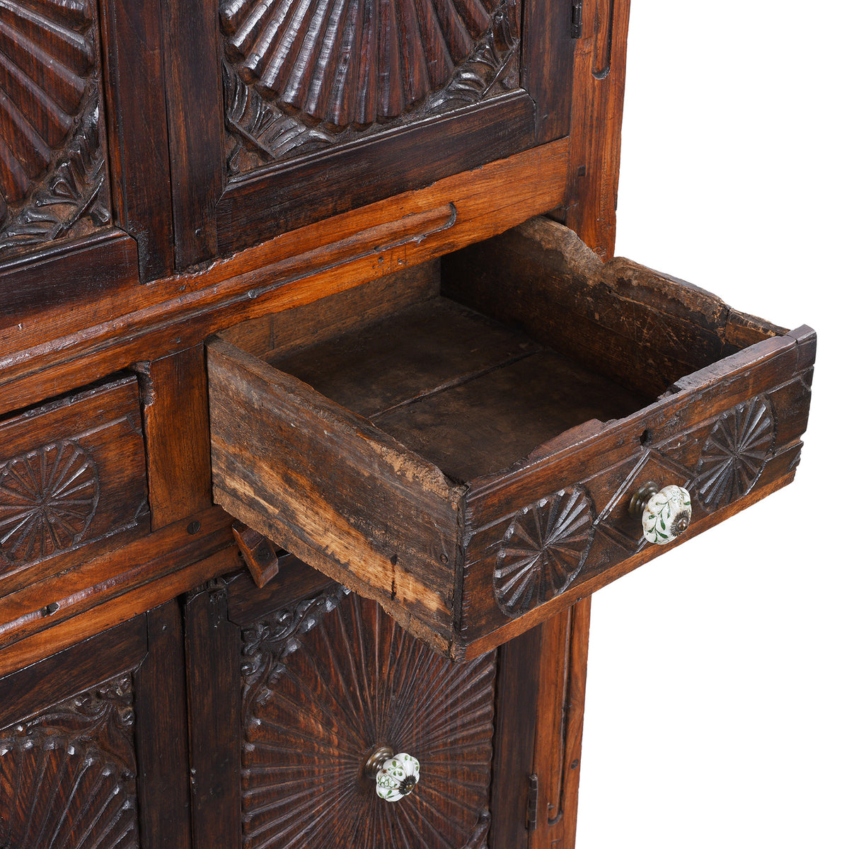 Open Drawer View From Indian Teak Almirah Cabinet With Hand-Carved Sunburst Panels, Two Drawers And White Ceramic Handles