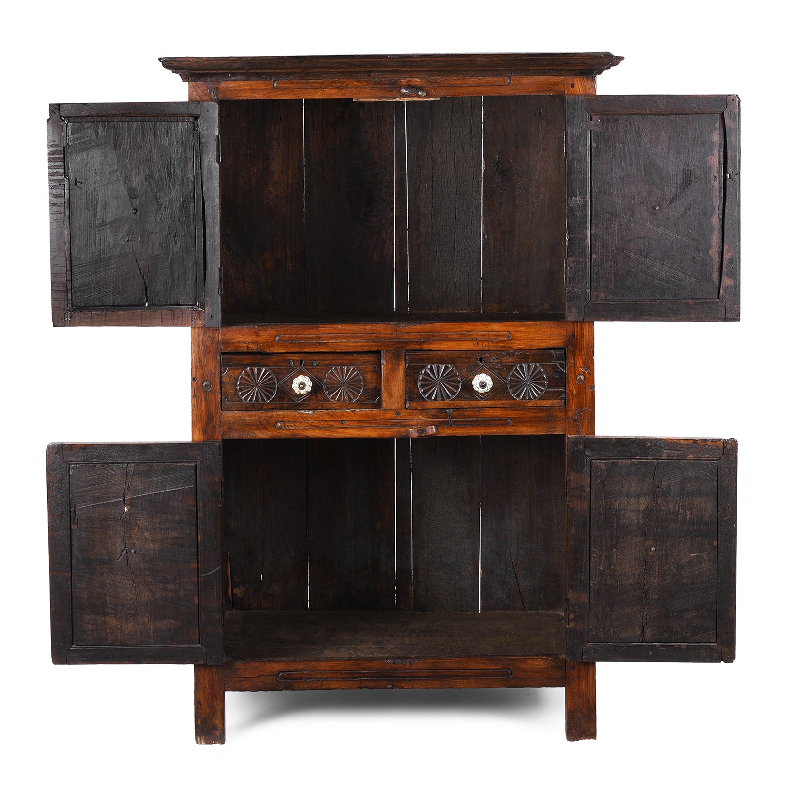 Interior View Of Indian Teak Almirah Cabinet With Hand-Carved Sunburst Panels, Two Drawers And White Ceramic Handles