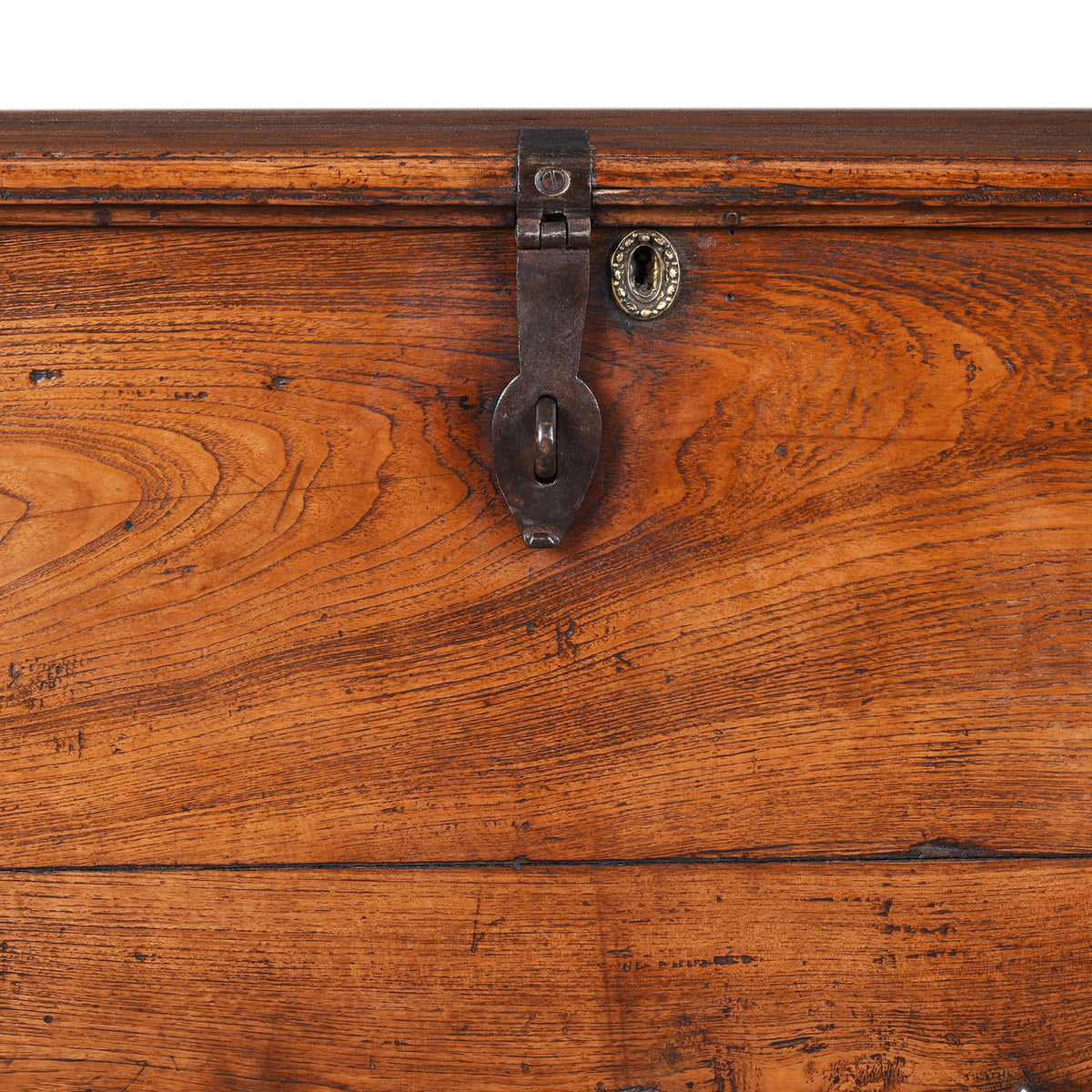 Latch And Keyhole Detail From Antique mid-19th century teak chest from Gujarat with hidden wheels, carved floral feet, and original iron fittings.
