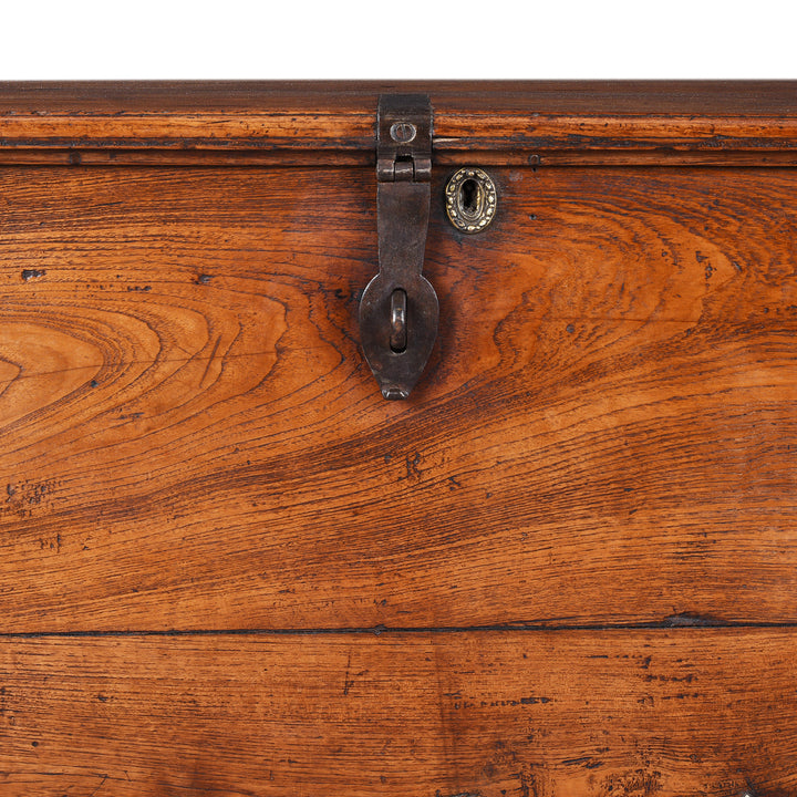 Latch And Keyhole Detail From Antique mid-19th century teak chest from Gujarat with hidden wheels, carved floral feet, and original iron fittings.