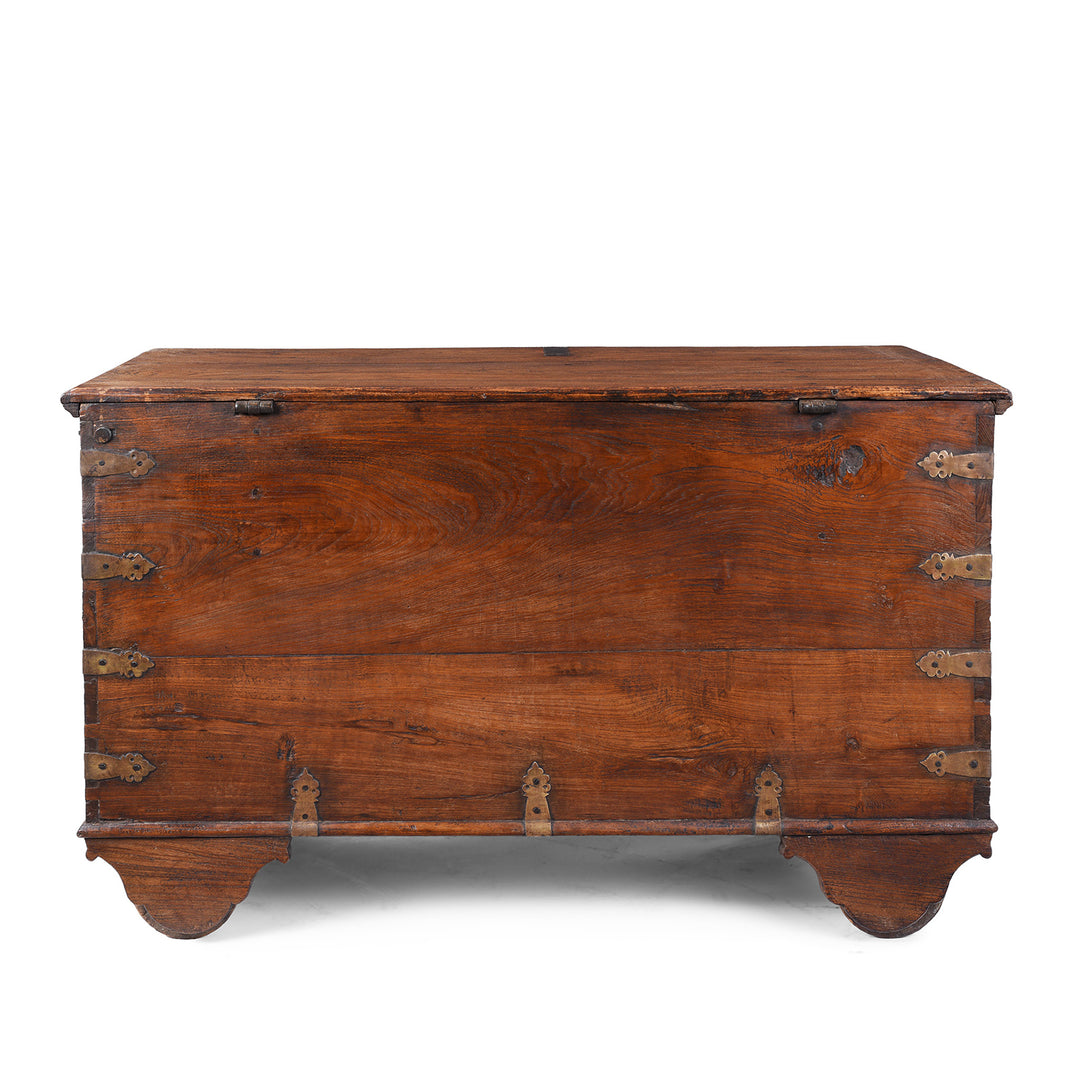 Back Of Antique mid-19th century teak chest from Gujarat with hidden wheels, carved floral feet, and original iron fittings.