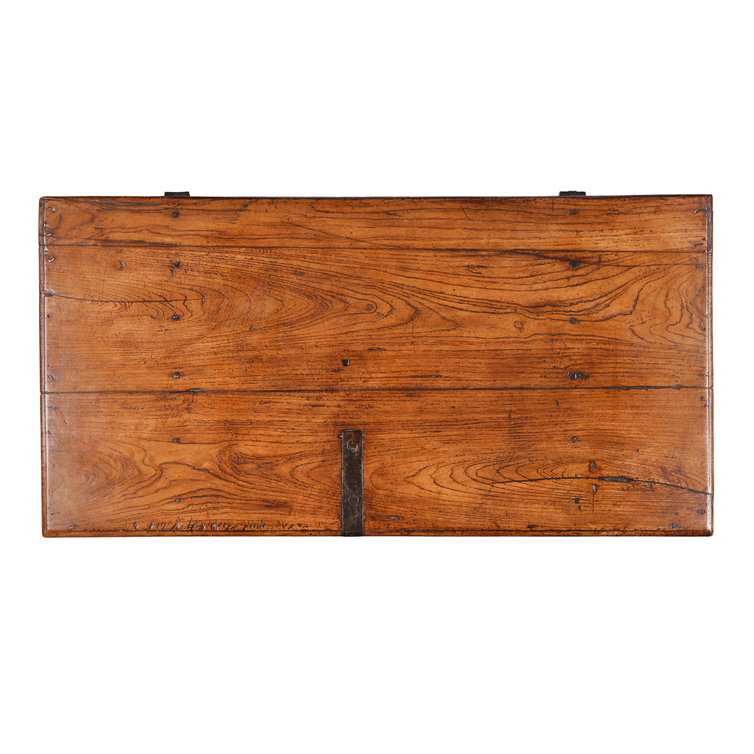 Top Down View Of Antique mid-19th century teak chest from Gujarat with hidden wheels, carved floral feet, and original iron fittings.