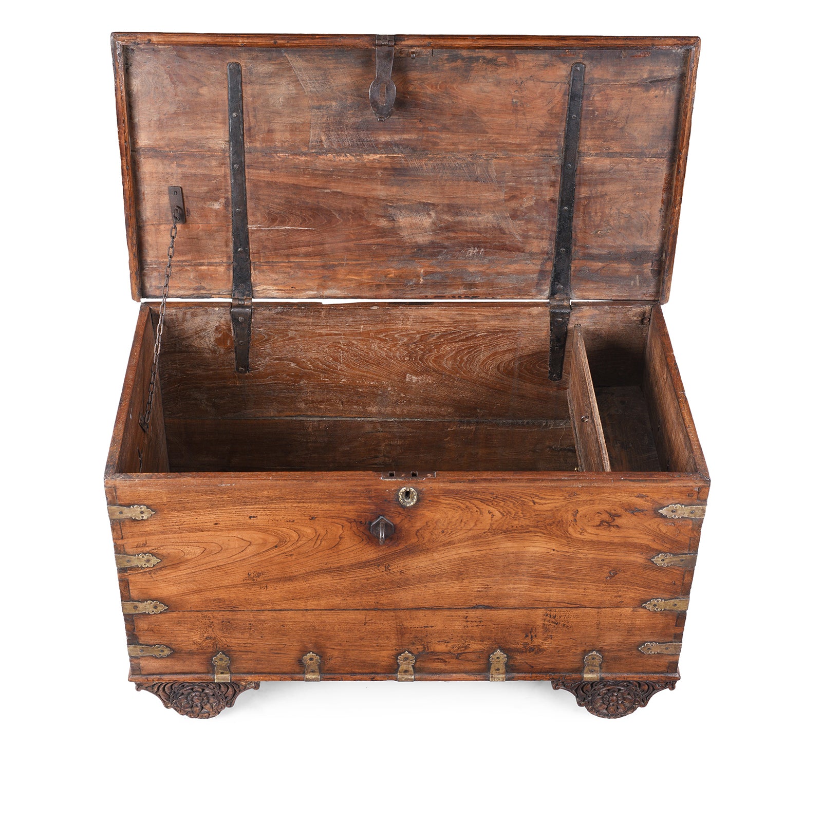 P[em View Of Antique mid-19th century teak chest from Gujarat with hidden wheels, carved floral feet, and original iron fittings.
