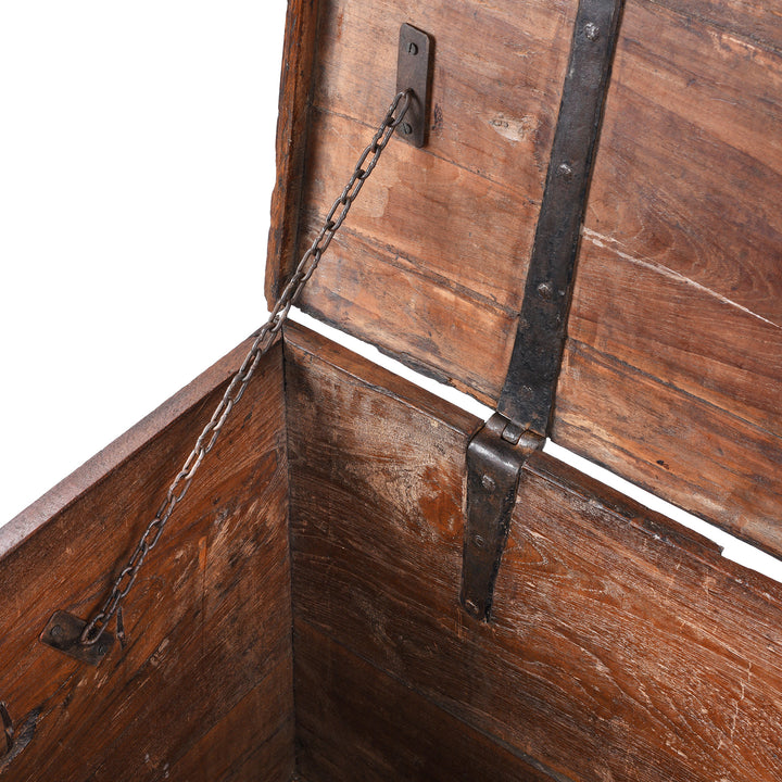 Chain Detail From Antique mid-19th century teak chest from Gujarat with hidden wheels, carved floral feet, and original iron fittings.