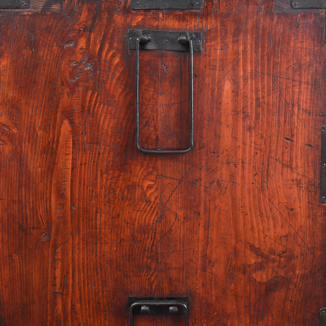 Handle Detail From Side Of Antique Japanese Tansu Chest With Lacquered Wood Finish And Ornate Iron Hardware